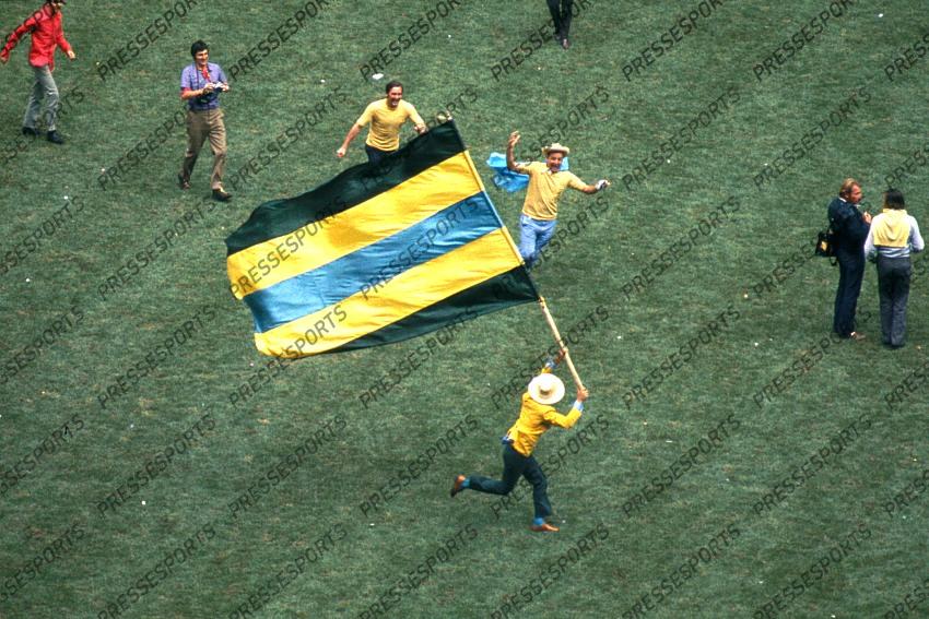 A Brazillian fan charges round the pitch with a flag after they win the World Cup against Italy beating them 4-1 in Mexico. 21 June 1970 