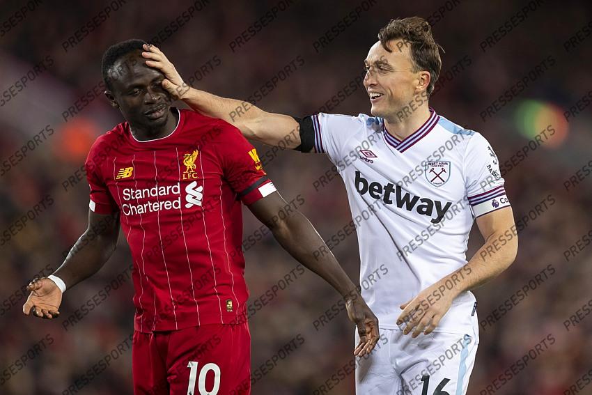24 February 2020, Liverpool - Premier League Football - Liverpool v West Ham United. Mark Noble of West Ham United shares a joke with Sadio Mane of Liverpool (photo by Daniel Chesterton) 