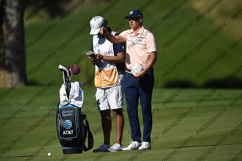 Oct 15, 2020; Las Vegas, Nevada, USA; Jordan Spieth throws grass in the air with his caddy standing beside him on the second hole during the first round of the CJ Cup golf tournament at Shadow Creek Golf Course. Mandatory Credit: Kelvin Kuo-USA TODAY Sports 