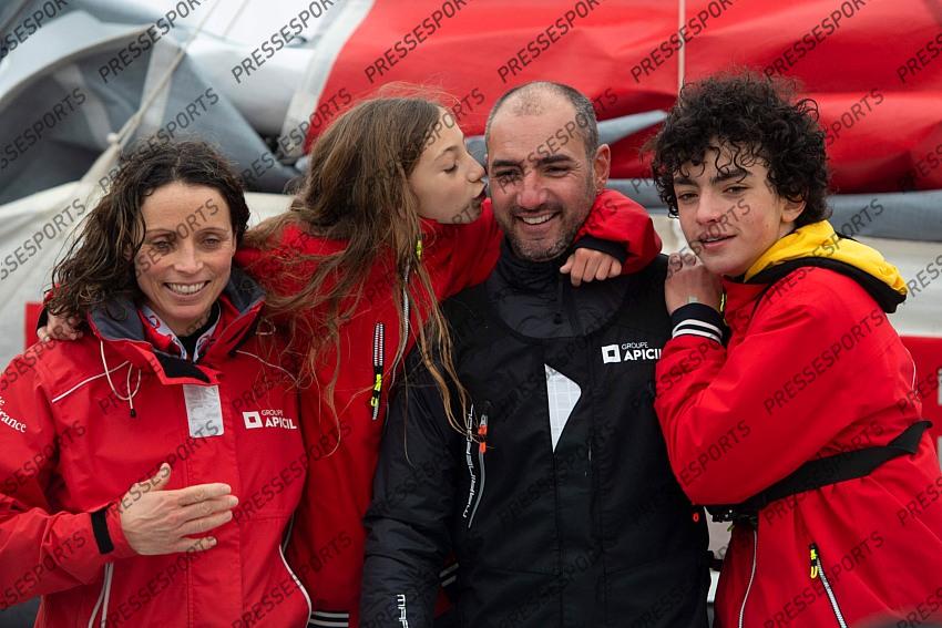 French skipper Damien Seguin (2nd R) poses with wife and children after crossing the finish line of the Vendee Globe round-the-world solo sailing race, at Les Sables d'Olonne, western France, on January 28, 2021. - Seguin, who sailed the Imoca 60 monohull "Groupe Apicil", finished in sixth position. (Photo by LOIC VENANCE / POOL / AFP) 