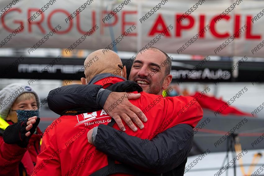 French skipper Damien Seguin (R) celebrates after crossing the finish line of the Vendee Globe round-the-world solo sailing race, at Les Sables d'Olonne, western France, on January 28, 2021. - Seguin, who sailed the Imoca 60 monohull "Groupe Apicil", finished in sixth position. (Photo by LOIC VENANCE / POOL / AFP) 