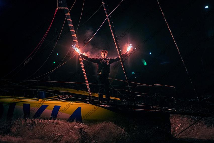 French skipper Charlie Dalin, 36, sails his Imoca 60 monohull "Apivia" across the finish line in the 2020/2021 ninth edition of the Vendee Globe round-the-world solo race off the coasts of Les Sables d'Olonne, western France, on January 27, 2021, - Dalin completed the epic race in 80 days, six hours, 15 minutes and 47 seconds. However, Germany's Boris Herrmann (SeaExplorer-Yacht Club de Monaco) and France's Yannick Bestaven (Maitre coq IV) are still in the running for the title. (Photo by LOIC VENANCE / POOL / AFP) 