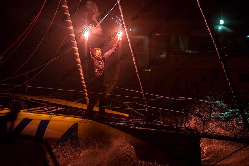 French skipper Charlie Dalin, 36, holds up flares as he sails his Imoca 60 monohull "Apivia" across the finish line in the 2020/2021 ninth edition of the Vendee Globe round-the-world solo race off the coasts of Les Sables d'Olonne, western France, on January 27, 2021. - Dalin completed the epic race in 80 days, six hours, 15 minutes and 47 seconds. However, Germany's Boris Herrmann (SeaExplorer-Yacht Club de Monaco) and France's Yannick Bestaven (Maitre coq IV) are still in the running for the title. (Photo by LOIC VENANCE / POOL / AFP) 
