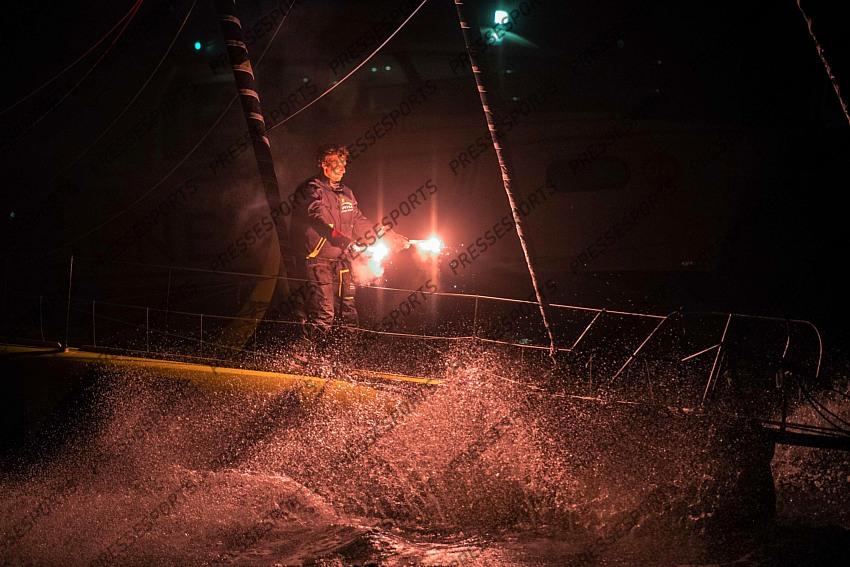 French skipper Charlie Dalin, 36, holds up flares as he sails his Imoca 60 monohull "Apivia" across the finish line in the 2020/2021 ninth edition of the Vendee Globe round-the-world solo race off the coasts of Les Sables d'Olonne, western France, on January 27, 2021. - Dalin completed the epic race in 80 days, six hours, 15 minutes and 47 seconds. However, Germany's Boris Herrmann (SeaExplorer-Yacht Club de Monaco) and France's Yannick Bestaven (Maitre coq IV) are still in the running for the title. (Photo by LOIC VENANCE / POOL / AFP) 
