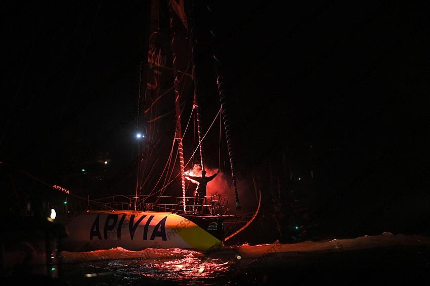 French skipper Charlie Dalin, 36, holds up flares as he sails his Imoca 60 monohull "Apivia" across the finish line in the 2020/2021 ninth edition of the Vendee Globe round-the-world solo race off the coasts of Les Sables d'Olonne, western France, on January 27, 2021. - Dalin completed the epic race in 80 days, six hours, 15 minutes and 47 seconds. However, Germany's Boris Herrmann (SeaExplorer-Yacht Club de Monaco) and France's Yannick Bestaven (Maitre coq IV) are still in the running for the title. (Photo by LOIC VENANCE / POOL / AFP) 