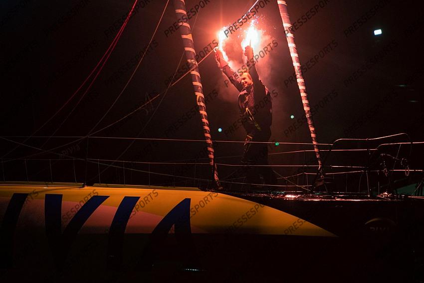 French skipper Charlie Dalin, 36, holds up flares as he sails his Imoca 60 monohull "Apivia" across the finish line in the 2020/2021 ninth edition of the Vendee Globe round-the-world solo race off the coasts of Les Sables d'Olonne, western France, on January 27, 2021. - Dalin completed the epic race in 80 days, six hours, 15 minutes and 47 seconds. However, Germany's Boris Herrmann (SeaExplorer-Yacht Club de Monaco) and France's Yannick Bestaven (Maitre coq IV) are still in the running for the title. (Photo by LOIC VENANCE / POOL / AFP) 