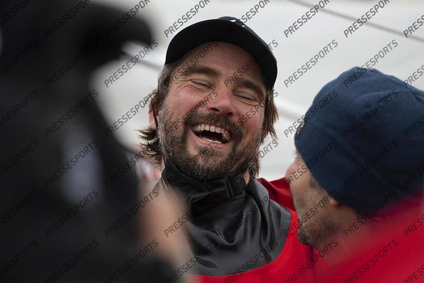 German skipper Boris Herrmann celebrates with Champagne after crossing the finish line of the Vendee Globe round-the-world solo sailing race, at Les Sables d'Olonne, western France, Thursday, Jan. 28, 2021. French sailor Yannick Bestaven won the Vendee Globe solo round-the-world race after more than 80 days and an unusually close final few hours to determine the winner on Thursday. (Loic Venance, Pool via AP) 