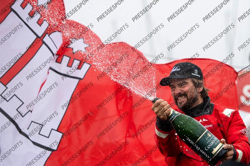 German skipper Boris Herrmann celebrates with Champagne after crossing the finish line of the Vendee Globe round-the-world solo sailing race, at Les Sables d'Olonne, western France, Thursday, Jan. 28, 2021. French sailor Yannick Bestaven won the Vendee Globe solo round-the-world race after more than 80 days and an unusually close final few hours to determine the winner on Thursday. (Loic Venance, Pool via AP) 