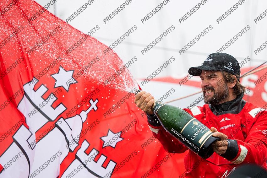 German skipper Boris Herrmann celebrates with Champagne after crossing the finish line of the Vendee Globe round-the-world solo sailing race, at Les Sables d'Olonne, western France, Thursday, Jan. 28, 2021. French sailor Yannick Bestaven won the Vendee Globe solo round-the-world race after more than 80 days and an unusually close final few hours to determine the winner on Thursday. (Loic Venance, Pool via AP) 