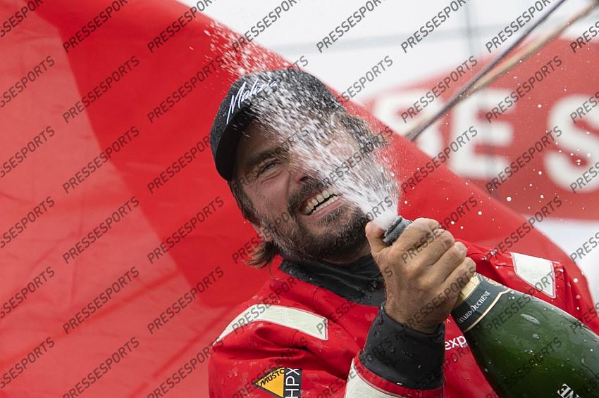 German skipper Boris Herrmann celebrates with Champagne after crossing the finish line of the Vendee Globe round-the-world solo sailing race, at Les Sables d'Olonne, western France, Thursday, Jan. 28, 2021. French sailor Yannick Bestaven won the Vendee Globe solo round-the-world race after more than 80 days and an unusually close final few hours to determine the winner on Thursday. (Loic Venance, Pool via AP) 