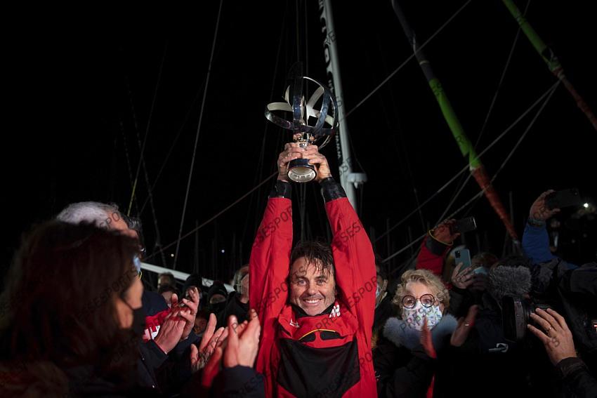 Frenchman Yannick Bestaven lifts his trophy after winning the Vendee Globe solo round-the-world sailing race Thursday, Jan.28, 2021 in Les Sables-d'Olonne, western France. The 48-year-old Bestaven wasn't the first to cross the finish line ‚Äî that honor went to fellow Frenchman Charlie Dalin, who arrived in Les Sables-d'Olonne Wednesday night. (Loic Venance, Pool via AP) 