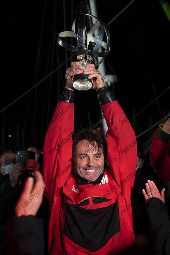 Frenchman Yannick Bestaven lifts his trophy after winning the Vendee Globe solo round-the-world sailing race Thursday, Jan.28, 2021 in Les Sables-d'Olonne, western France. The 48-year-old Bestaven wasn't the first to cross the finish line ‚Äî that honor went to fellow Frenchman Charlie Dalin, who arrived in Les Sables-d'Olonne Wednesday night. (Loic Venance, Pool via AP) 