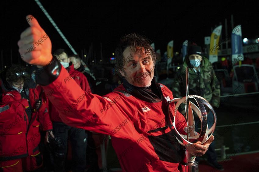 Frenchman Yannick Bestaven thumbs up his trophy after winning the Vendee Globe solo round-the-world sailing race Thursday, Jan.28, 2021 in Les Sables-d'Olonne, western France. The 48-year-old Bestaven wasn't the first to cross the finish line ‚Äî that honor went to fellow Frenchman Charlie Dalin, who arrived in Les Sables-d'Olonne Wednesday night. (Loic Venance, Pool via AP) 