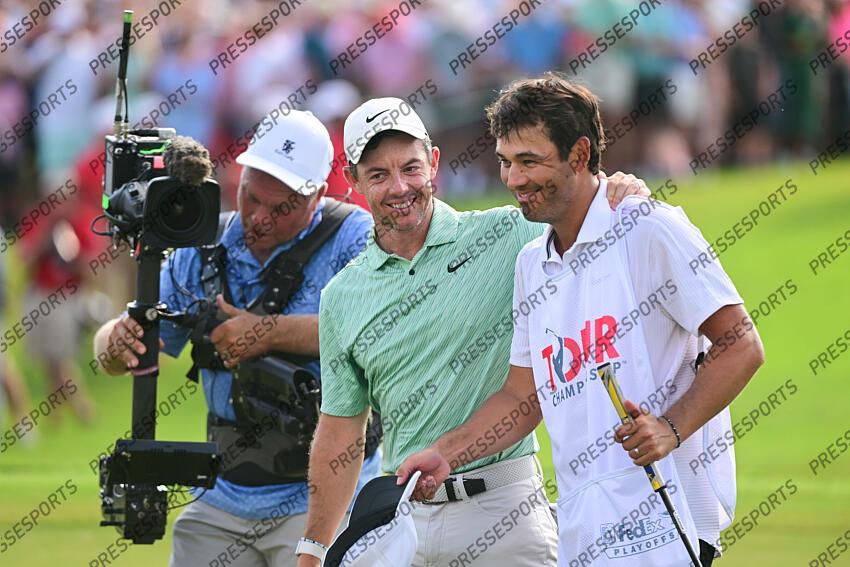 Aug 28, 2022; Atlanta, Georgia, USA; Rory McIlroy and his caddie Harry Diamond walk off the 18th green after winning the TOUR Championship golf tournament. Mandatory Credit: Adam Hagy-USA TODAY Sports FINALE FEDEX CUP 
