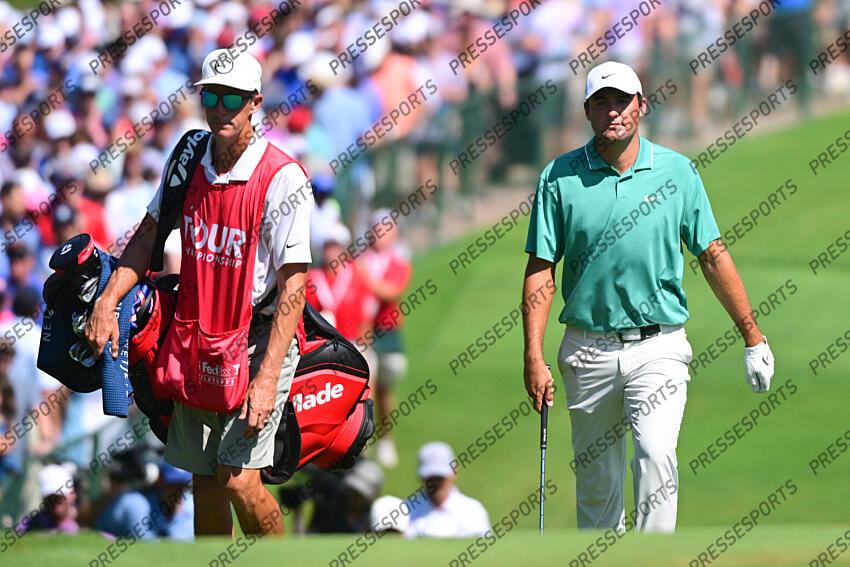 Aug 28, 2022; Atlanta, Georgia, USA; Scottie Scheffler and his caddie Ted Scott walk up to the 9th green during the final round of the TOUR Championship golf tournament. Mandatory Credit: Adam Hagy-USA TODAY Sports FINALE FEDEX CUP 