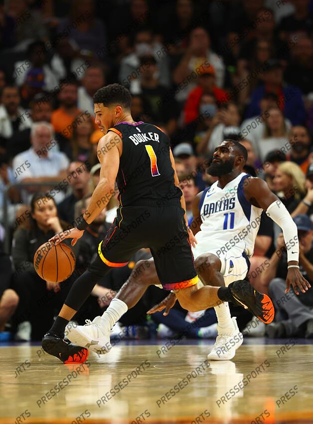 Oct 19, 2022; Phoenix, Arizona, USA; Phoenix Suns guard Devin Booker (1) rolls his ankle against Dallas Mavericks forward Tim Hardaway Jr. in the second half at Footprint Center. Mandatory Credit: Mark J. Rebilas-USA TODAY Sports NBA: Dallas Mavericks at Phoenix Suns 