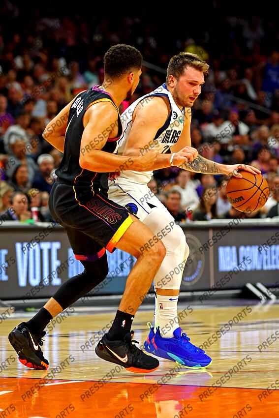 Oct 19, 2022; Phoenix, Arizona, USA; Dallas Mavericks guard Luka Doncic (77) handles the ball against Phoenix Suns guard Devin Booker (1) during the third quarter at Footprint Center. Mandatory Credit: Mark J. Rebilas-USA TODAY Sports NBA: Dallas Mavericks at Phoenix Suns 