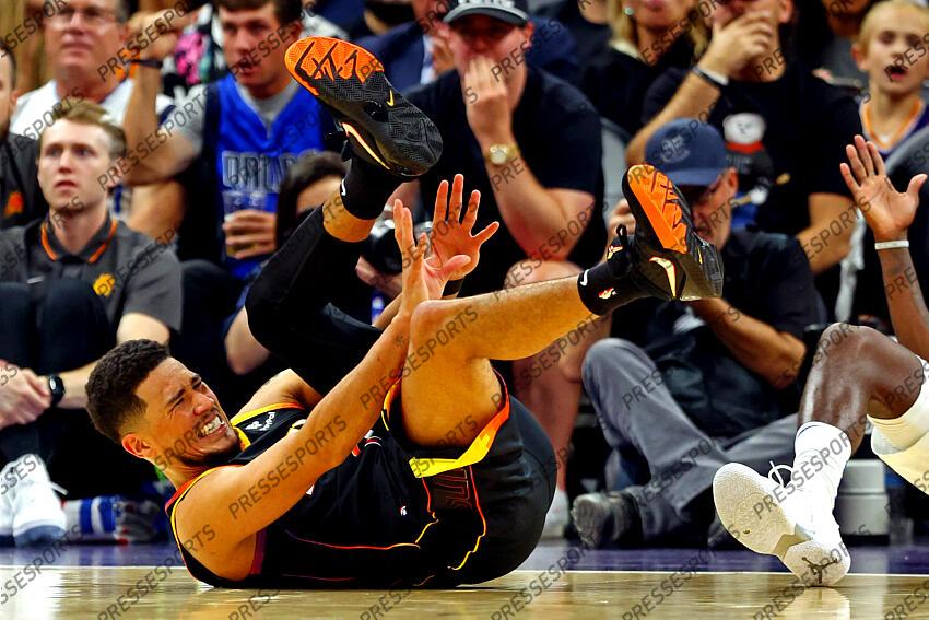Oct 19, 2022; Phoenix, Arizona, USA; Phoenix Suns guard Devin Booker (1) reacts as he falls to the court during the third quarter against the Dallas Mavericks at Footprint Center. Mandatory Credit: Mark J. Rebilas-USA TODAY Sports NBA: Dallas Mavericks at Phoenix Suns 