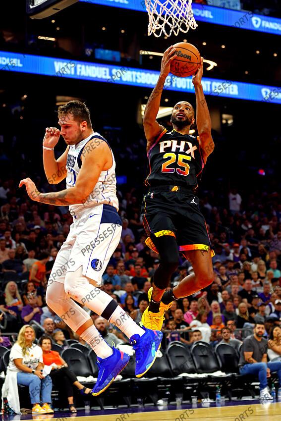 Oct 19, 2022; Phoenix, Arizona, USA; Phoenix Suns forward Mikal Bridges (25) shoots the ball against Dallas Mavericks guard Luka Doncic (77) during the second quarter at Footprint Center. Mandatory Credit: Mark J. Rebilas-USA TODAY Sports NBA: Dallas Mavericks at Phoenix Suns 