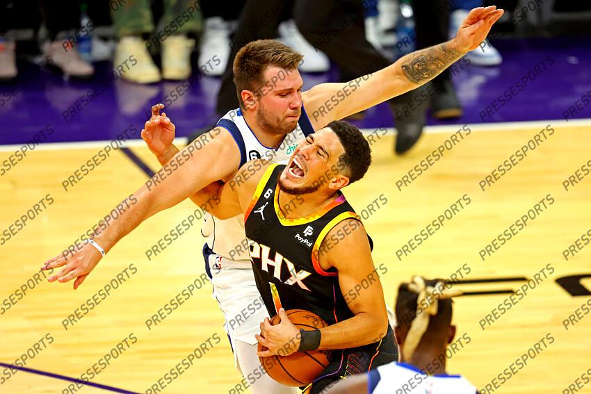 Oct 19, 2022; Phoenix, Arizona, USA; Phoenix Suns guard Devin Booker (1) drives to the basket against Dallas Mavericks guard Luka Doncic (77) during the first quarter at Footprint Center. Mandatory Credit: Mark J. Rebilas-USA TODAY Sports NBA: Dallas Mavericks at Phoenix Suns 
