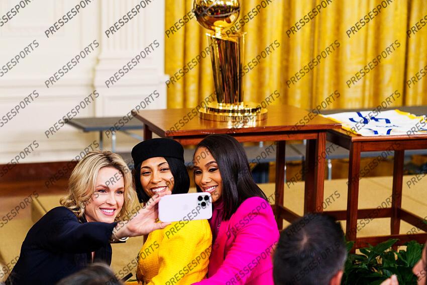 Jan 17, 2023; Washington, DC, USA; Loved ones of Golden State Warriors players take a selfie in front of the championship trophy in the East Room of the White House before a ceremony to celebrate their 2022 NBA championship. Mandatory Credit: Josh Morgan-USA TODAY GOLDEN STATE WARRIORS A LA MAISON BLANCHE 