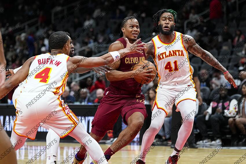 Oct 10, 2023; Atlanta, Georgia, USA; Cleveland Cavaliers forward Isaac Okoro (35) drives to the basket against Atlanta Hawks forward Saddiq Bey (41) and guard Kobe Bufkin (4) during the second half at State Farm Arena. Mandatory Credit: Dale Zanine-USA TODAY Sports NBA: Preseason-Cleveland Cavaliers at Atlanta Hawks 