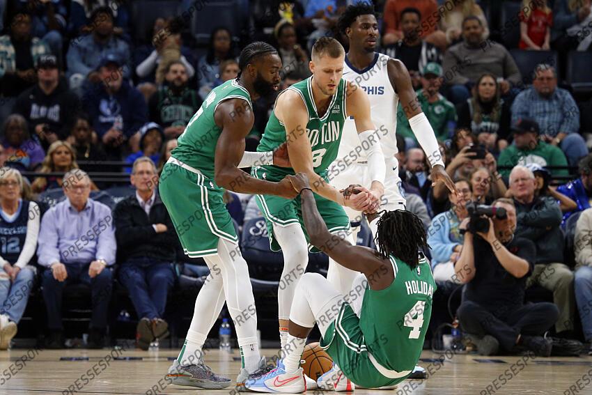 Nov 19, 2023; Memphis, Tennessee, USA; Boston Celtics guard Jaylen Brown (7) and center Kristaps Porzingis (8) help guard Jrue Holiday (4) up during the second half against the Memphis Grizzlies at FedExForum. Mandatory Credit: Petre Thomas-USA TODAY Sports NBA: Boston Celtics at Memphis Grizzlies 