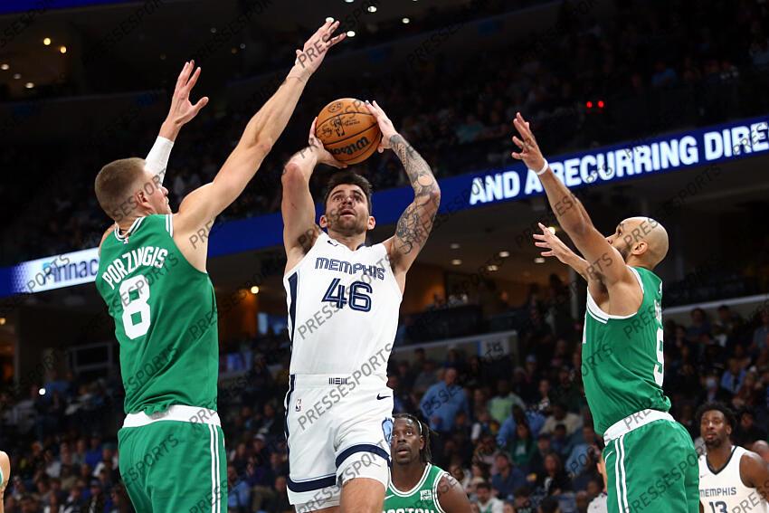 Nov 19, 2023; Memphis, Tennessee, USA; Memphis Grizzlies guard John Konchar (46) drives to the basket between Boston Celtics center Kristaps Porzingis (8) and guard Derrick White (9) during the second half at FedExForum. Mandatory Credit: Petre Thomas-USA TODAY Sports NBA: Boston Celtics at Memphis Grizzlies 