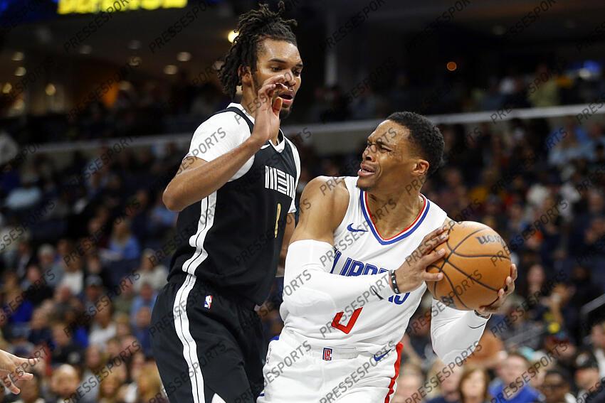 Feb 23, 2024; Memphis, Tennessee, USA; Los Angeles Clippers guard Russell Westbrook (0) drives to the basket as Memphis Grizzlies forward Ziaire Williams (8) defends during the second half at FedExForum. Mandatory Credit: Petre Thomas-USA TODAY Sports NBA: Los Angeles Clippers at Memphis Grizzlies 
