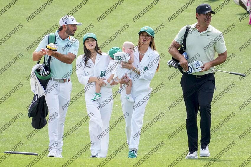 Apr 10, 2024; Augusta, Georgia, USA; Max Homa walks with his wife, Lacey Croom, and son Cam, along with Brooks Koepka and his wife, Jena Sims and son Crew, down the no. 1 fairway during the Par 3 Contest at Augusta National Golf Club. Mandatory Credit: Michael Madrid-USA TODAY Network concours par 3 PGA: Masters Tournament - Par 3 Contest 
