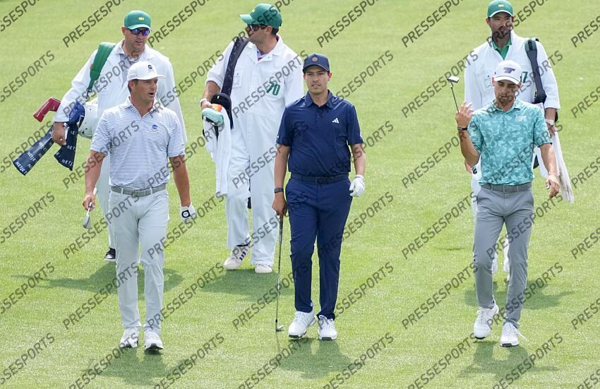 Apr 10, 2024; Augusta, Georgia, USA; Bryson DeChambeau, Santiago de la Fuente and Joaquin Niemann walk the no. 1 fairway during the Par 3 Contest at Augusta National Golf Club. Mandatory Credit: Michael Madrid-USA TODAY Network concours par 3 PGA: Masters Tournament - Par 3 Contest 