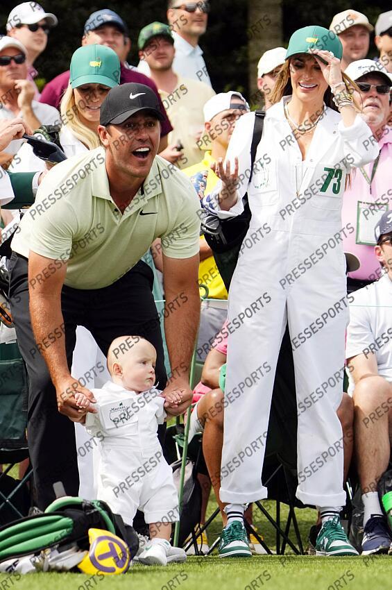 Apr 10, 2024; Augusta, Georgia, USA; Brooks Koepka holds his son Crew as his wife Jena Sims looks on on the No. 3 tee during the Par 3 Contest at Augusta National Golf Club. Mandatory Credit: Rob Schumacher-USA TODAY Network concours par 3 PGA: Masters Tournament - Par 3 Contest 