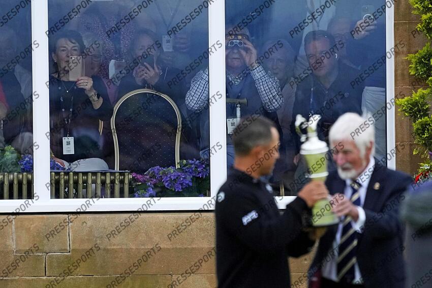 Jul 21, 2024; Ayrshire, SCT; Spectators watch from the club hour as Xander Schauffele is present the Claret Jug after winning the Open Championship golf tournament at Royal Troon. Mandatory Credit: Jack Gruber-USA TODAY Sports PGA: The Open Championship - Final Round 