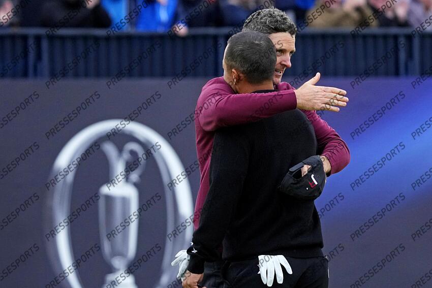 Jul 21, 2024; Ayrshire, SCT; Justin Rose hugs Xander Schauffele on the 18th green during the final round of the Open Championship golf tournament at Royal Troon. Mandatory Credit: Jack Gruber-USA TODAY Sports PGA: The Open Championship - Final Round 