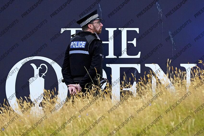 Jul 21, 2024; Ayrshire, SCT; A police officer looks on on the 18th green during the final round of the Open Championship golf tournament at Royal Troon. Mandatory Credit: Jack Gruber-USA TODAY Sports PGA: The Open Championship - Final Round 
