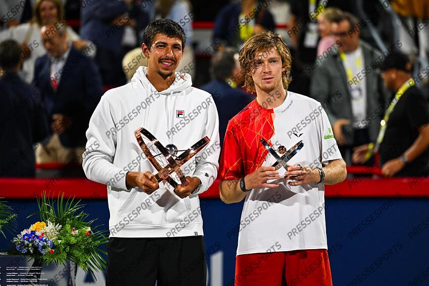 Aug 12, 2024; Montreal, Quebec, Canada; Alexei Popyrin (AUS) winner of the singles final holds his trophy beside finalist Andrey Rublev at IGA Stadium. Mandatory Credit: David Kirouac-USA TODAY Sports FINALE POPYRIN/RUBLEV 