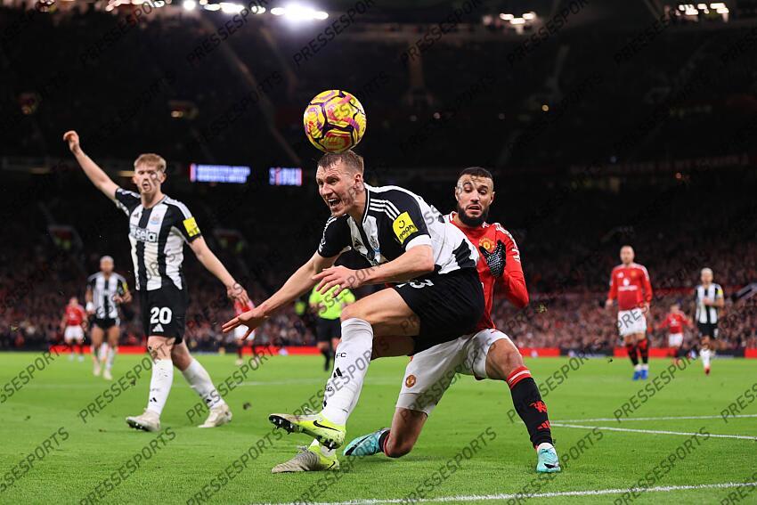 30th December 2024 - Premier League - Manchester United v Newcastle United - Dan Burn of Newcastle United battles with Noussair Mazraoui of Manchester United - Photo: Simon Stacpoole / Offside. MANCHESTER UNITED-NEWCASTLE UNITED (0-2) 