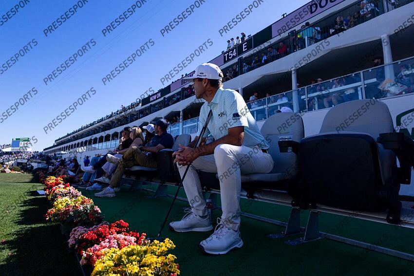 Feb 6, 2025; Scottsdale, Arizona, USA; Ben Martin of the United States sits down in a front row seat at hole 16 as he watches his competitors during the first round of the WM Phoenix Open golf tournament. Mandatory Credit: Aryanna Frank-Imagn Images PGA: WM Phoenix Open - First Round 