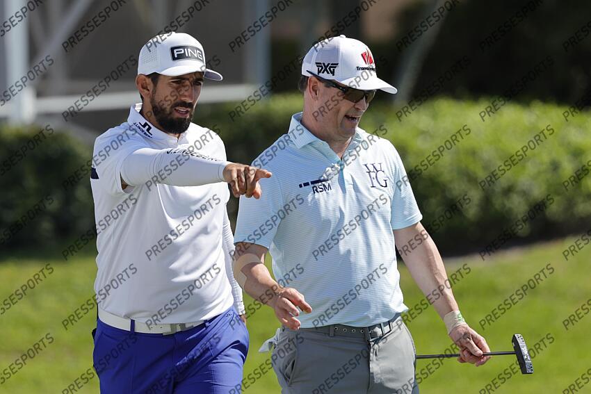 Feb 28, 2025; Palm Beach Gardens, Florida, USA; Mathieu Pavon (left) and Zach Johnson talk on the 16th green during the second round of the Cognizant Classic in The Palm Beaches golf tournament. Mandatory Credit: Reinhold Matay-Imagn Images PGA: Cognizant Classic in The Palm Beaches - Second Round 