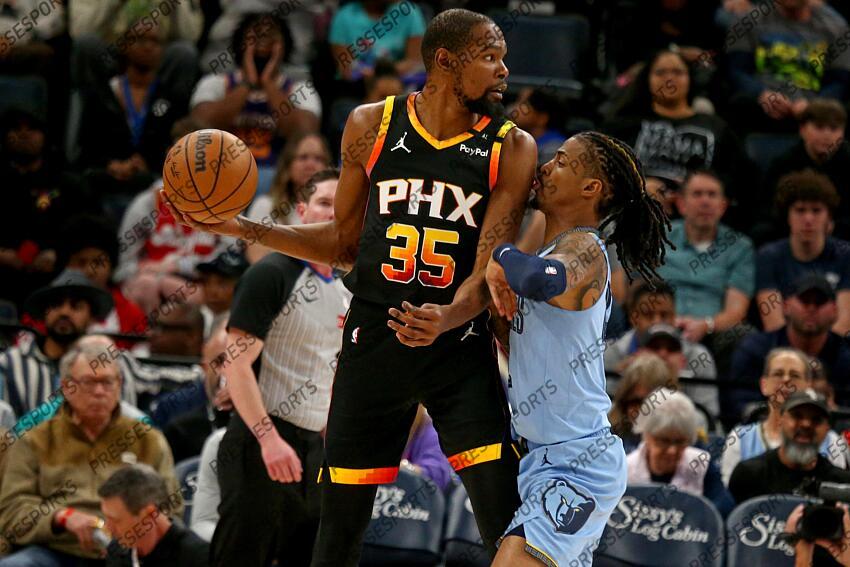 Mar 10, 2025; Memphis, Tennessee, USA; Phoenix Suns forward Kevin Durant (35) handles the ball as Memphis Grizzlies guard Ja Morant (12) defends during the first quarter at FedExForum. Mandatory Credit: Petre Thomas-Imagn Images NBA: Phoenix Suns at Memphis Grizzlies 