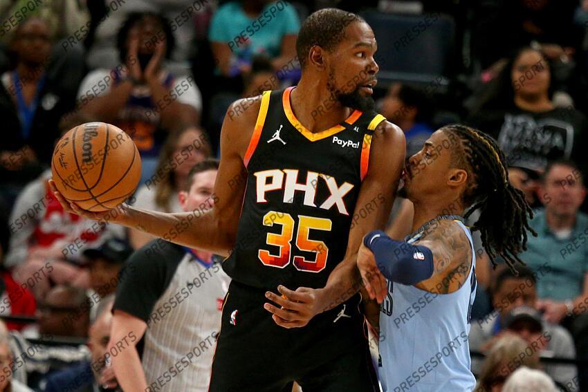 Mar 10, 2025; Memphis, Tennessee, USA; Phoenix Suns forward Kevin Durant (35) handles the ball as Memphis Grizzlies guard Ja Morant (12) defends during the first quarter at FedExForum. Mandatory Credit: Petre Thomas-Imagn Images NBA: Phoenix Suns at Memphis Grizzlies 