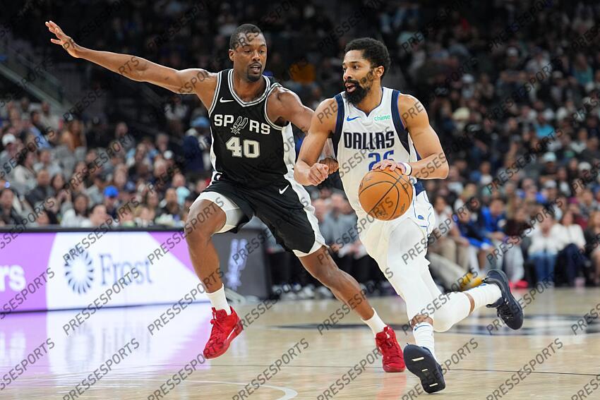 Mar 10, 2025; San Antonio, Texas, USA; Dallas Mavericks guard Spencer Dinwiddie (26) dribbles against San Antonio Spurs forward Harrison Barnes (40) in the second half at Frost Bank Center. Mandatory Credit: Daniel Dunn-Imagn Images NBA: Dallas Mavericks at San Antonio Spurs 