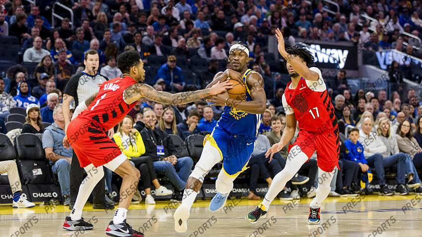 Mar 10, 2025; San Francisco, California, USA; Golden State Warriors forward Jimmy Butler III (10) drives past Portland Trail Blazers guard Shaedon Sharpe (17) and guard Anfernee Simons (1) during the second quarter at Chase Center. Mandatory Credit: John Hefti-Imagn Images NBA: Portland Trail Blazers at Golden State Warriors 