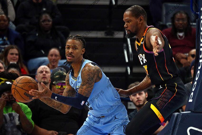 Mar 10, 2025; Memphis, Tennessee, USA; Memphis Grizzlies guard Ja Morant (12) handles the ball as Phoenix Suns forward Kevin Durant (35) defends during the fourth quarter at FedExForum. Mandatory Credit: Petre Thomas-Imagn Images NBA: Phoenix Suns at Memphis Grizzlies 