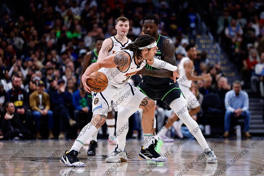Apr 1, 2025; Denver, Colorado, USA; Denver Nuggets forward Aaron Gordon (32) controls the ball as Minnesota Timberwolves forward Julius Randle (30) guards in the second quarter at Ball Arena. Mandatory Credit: Isaiah J. Downing-Imagn Images NBA: Minnesota Timberwolves at Denver Nuggets 