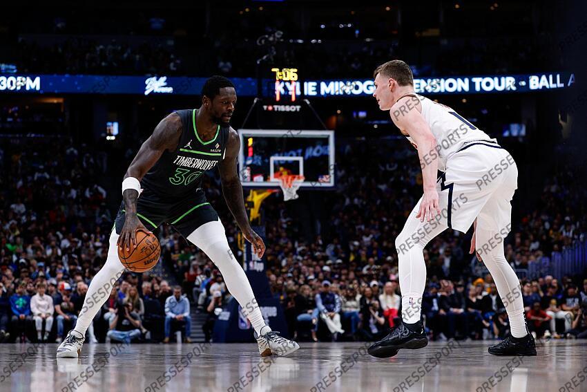Apr 1, 2025; Denver, Colorado, USA; Minnesota Timberwolves forward Julius Randle (30) controls the ball as Denver Nuggets guard Christian Braun (0) guards in the second quarter at Ball Arena. Mandatory Credit: Isaiah J. Downing-Imagn Images NBA: Minnesota Timberwolves at Denver Nuggets 