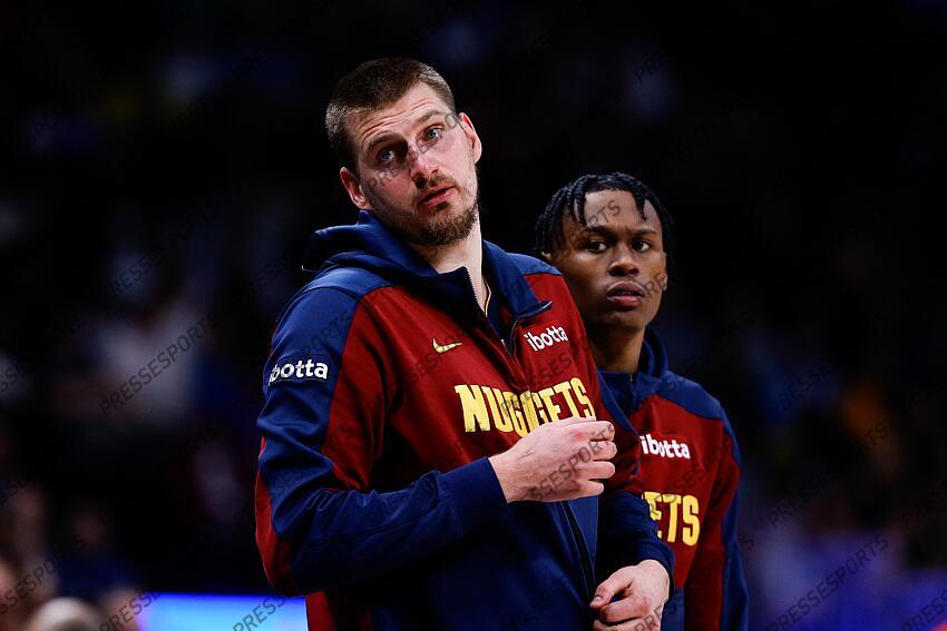 Apr 1, 2025; Denver, Colorado, USA; Denver Nuggets center Nikola Jokic (15) and forward Peyton Watson (8) look on from the sideline in the second quarter against the Minnesota Timberwolves at Ball Arena. Mandatory Credit: Isaiah J. Downing-Imagn Images NBA: Minnesota Timberwolves at Denver Nuggets 