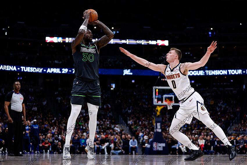 Apr 1, 2025; Denver, Colorado, USA; Minnesota Timberwolves forward Julius Randle (30) attempts a shot under pressure from Denver Nuggets guard Christian Braun (0) in the second quarter at Ball Arena. Mandatory Credit: Isaiah J. Downing-Imagn Images NBA: Minnesota Timberwolves at Denver Nuggets 