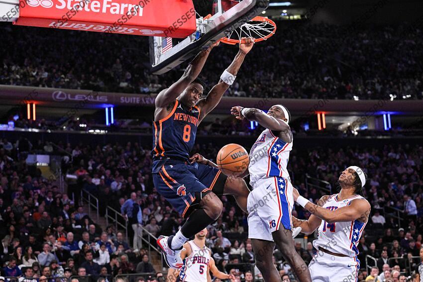 Apr 1, 2025; New York, New York, USA; New York Knicks forward OG Anunoby (8) dunks the ball as Philadelphia 76ers center Adem Bona (30) defends during the first half at Madison Square Garden. Mandatory Credit: John Jones-Imagn Images NBA: Philadelphia 76ers at New York Knicks 