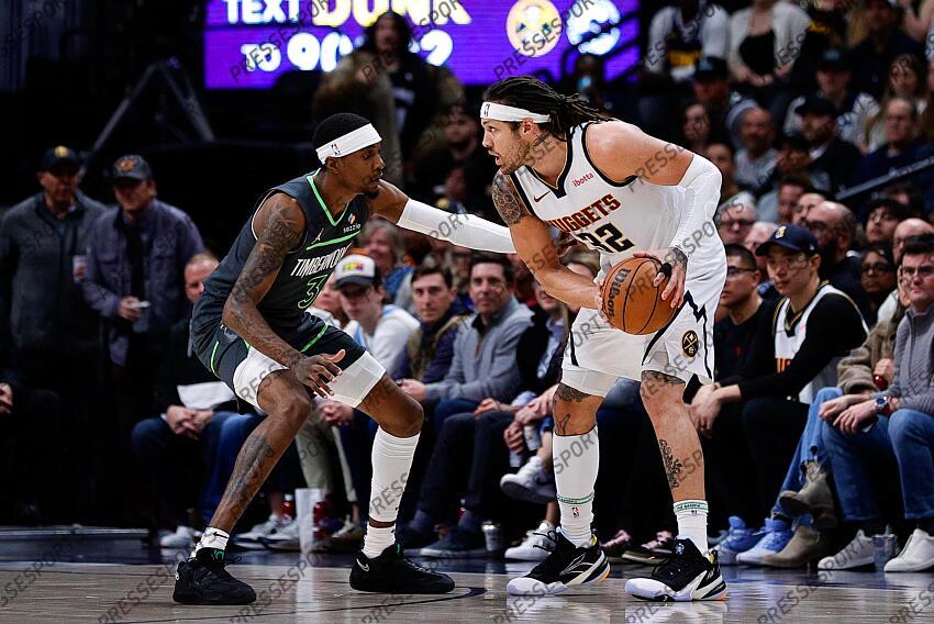 Apr 1, 2025; Denver, Colorado, USA; Denver Nuggets forward Aaron Gordon (32) controls the ball against Minnesota Timberwolves forward Jaden McDaniels (3) in the first quarter at Ball Arena. Mandatory Credit: Isaiah J. Downing-Imagn Images NBA: Minnesota Timberwolves at Denver Nuggets 